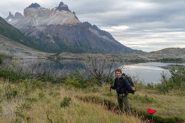 Fototapeta na wymiar Adult hiker with mountains and lake