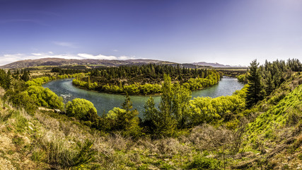 Fototapeta na wymiar Panoramic view of river canyon with dark water and spring