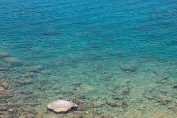 Fototapeta na wymiar Aerial view of clear blue green sea water with rocks, beautiful nature background