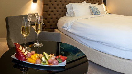 champagne glasses and fruit salad in hotel room