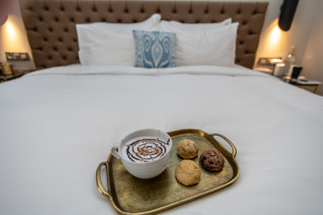 cappuccino with baked goods on tray