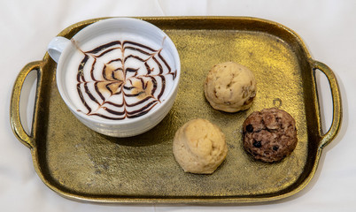 cappuccino with baked goods on tray