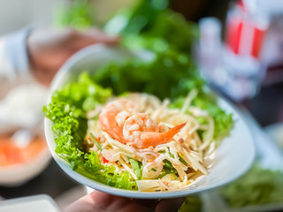 Close up salad mixed coconut spicy with shrimp Vietnam food background