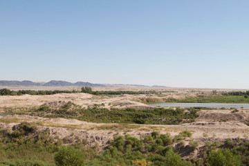 Fototapeta na wymiar Fields at the edge of the Kyzylkum Desert viewed from the Kyzyl Qala fortress (Uzbekistan)