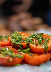 grilletd tomatos with parsley on a plate