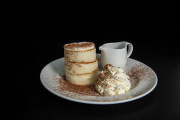 Fluffy Japan souffle pancakes, coffee syrup black background with copy space