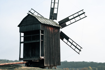Large wooden windmill against the sky. Abandoned windmill