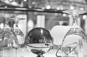 Closeup detail of silverware and wine glasses on set table of formal dining room or restaurant...