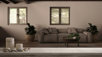 Wooden vintage table top or shelf with candles and pebbles, zen mood, over country house living room, lounge with wooden roof, mezzanine loft, sofa with pillows, carpet and plants