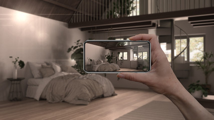 Hand holding smart phone, AR application, simulate furniture and interior design products in real home, architect designer concept, blur background, country bedroom with double bed