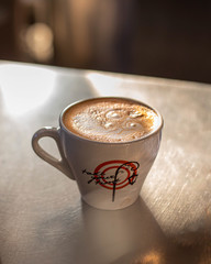 hot cappuccino latte art in white coffee cup close up drink