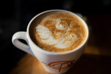 hot cappuccino latte art in white coffee cup close up drink 