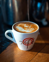 hot cappuccino latte art in white coffee cup close up drink