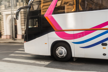 tourist bus is moving down the street