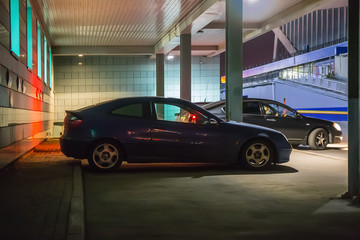 Naklejka na ściany i meble Cars at night in a parking lot