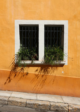 Provence style window, orange painted wall