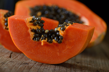 papaya sliced on wood background