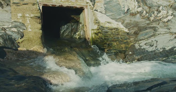 Water gushing from a tunnel in a rock