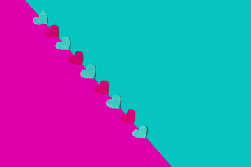 Pink and green background with felt hearts. Copy space. Place for text and design. Top view. Valentine's card