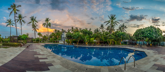 Swimming Pool with Palms at Sunset