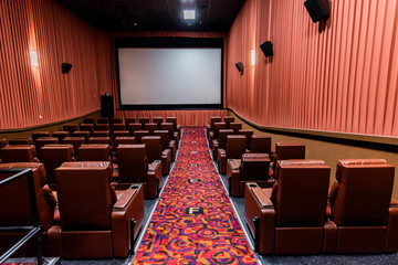 A recently renovated movie theater interior with luxurious reclining leather chairs