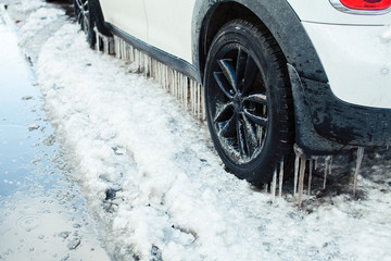 close up photo off car in iciles, a lot of water and snow, seasonal issues concept