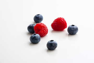blueberries and raspberries on the white