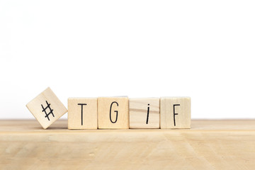 Wooden cubes with Hashtag and the word tgif, meaning Thank god its Friday, social media concept...