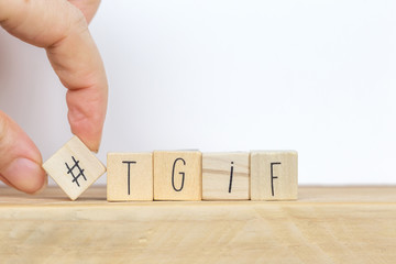 Wooden cubes with Hashtag and the word tgif, meaning Thank god its Friday, social media concept...