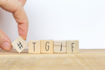 Wooden cubes with Hashtag and the word tgif, meaning Thank god its Friday, social media concept background