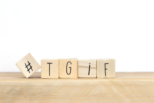 Wooden cubes with Hashtag and the word tgif, meaning Thank god its Friday, social media concept background