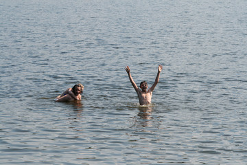 Dad, daughter and son bathe and swim in the lake. Russian family in the water