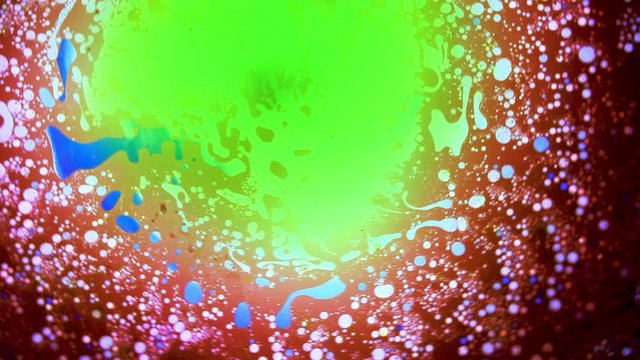 Abstract colorful paint reactions. Psychedelic liquid light show, dye curlicues. Marble background for visual effects, motion graphics. Swirl pattern, ink explosion, kaleidoscope. 60s disco oil wheel.