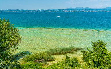 Jamaica Beach at Sirmione, on Lake Garda, renowed for its beautiful emerald water. Province of Brescia, Lombardy, Italy.