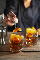 Tasty alcoholic old fashioned cocktail with orange slice.