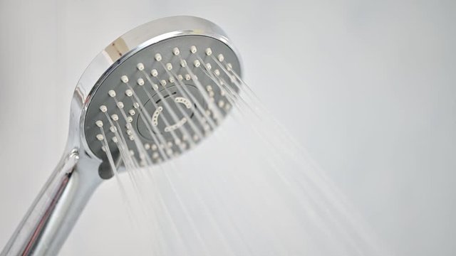 water flowing from shower in bathroom	