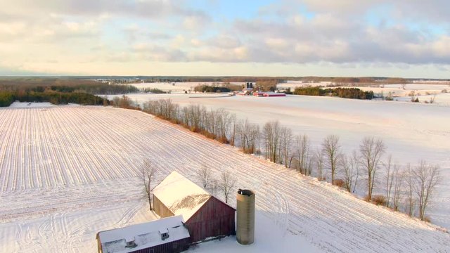 Stunning Wisconsin Winter rural landscape covered in fresh snow. Aerial view with long shadows at sunrise.