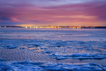 Frozen bay with city lights from Erie Pennsylvania in the background