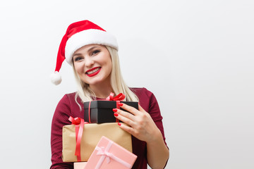 Happy young woman with christmas gifts over white background.