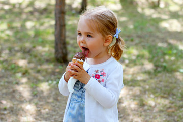 little girl eating ice cream in the park