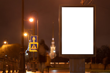 Vertical advertising billboard urban. city format in the night city. Luminous advertising field Mockup. landmark in the background