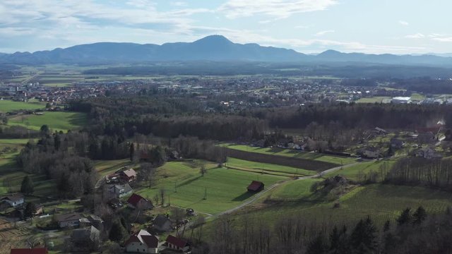 Aerial view of east Slovenian countryside, Slovenska Bistrica in front with Boc and Haloze hills in the background, view from Pohorje, European rural countryside, travel and eco tourism concept