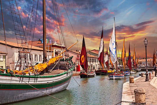 Cesenatico, Emilia Romagna, Italy: view at dawn of the port canal designed by Leonardo da Vinci in the ancient city on the Adriatic sea coast with the ancient wooden sailing boats