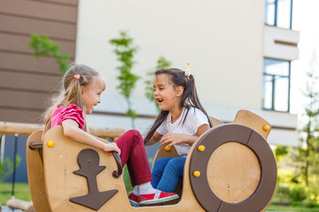 attractive little girl on outdoor playground equipment