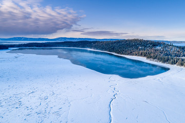 Naklejka na ściany i meble Little Payette Lake in winter aerial view with winding creek