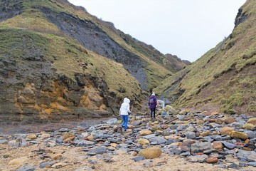 Family hiking in Hob Hole Beck, in Runswick Bay, North Yorkshire, England.