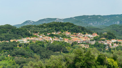 Fototapeta na wymiar Corfu, a small town built in the mountains between the trees, panorama from the Kaiser throne vantage point.