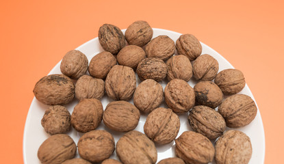 Walnuts on an orange background.