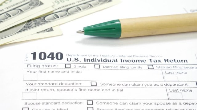 Blank Form 1040 U.S. Individual Income Tax Return with Pem and Dollar Bills. Tax Payment Concept. Filing Taxes Document