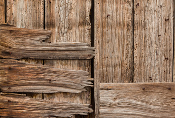 Old wooden boards with iron nails, holes and worn varnish background